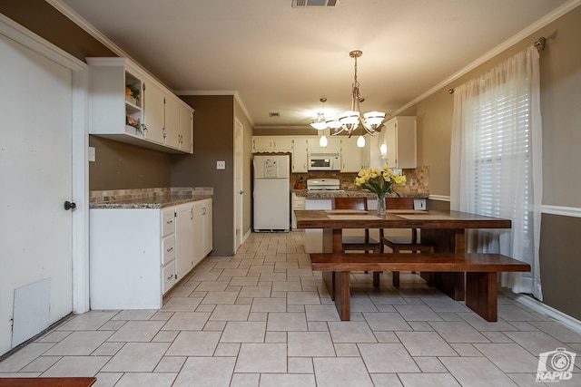140 Van Zandt St, San Angelo, TX 76905 - dining space featuring a chandelier and ornamental molding