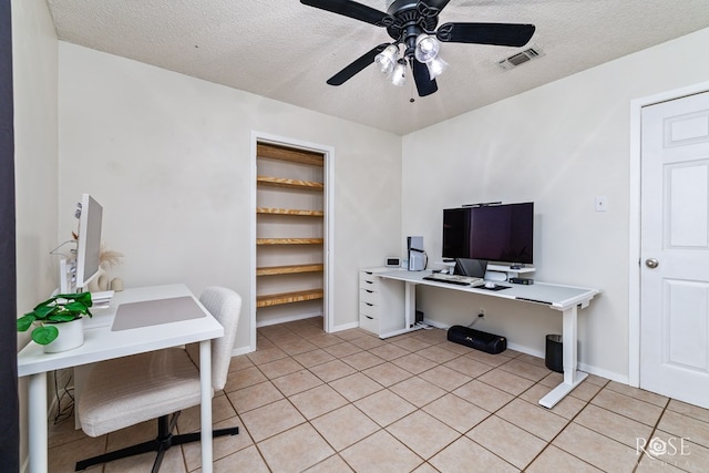 140 Van Zandt St, San Angelo, TX 76905 - home office featuring a textured ceiling, light tile patterned flooring, ceiling fan, and baseboards