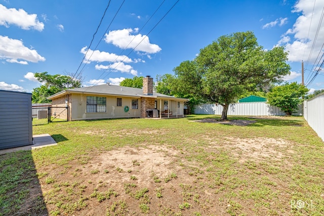 140 Van Zandt St, San Angelo, TX 76905 - rear view of house with a chimney and a gate