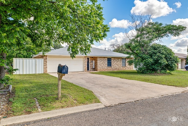 140 Van Zandt St, San Angelo, TX 76905 - view of front of property featuring a garage, concrete driveway, and brick siding