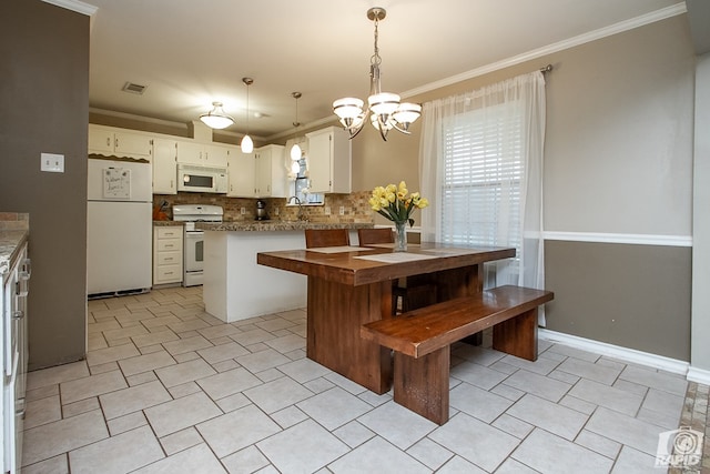 140 Van Zandt St, San Angelo, TX 76905 - kitchen featuring white appliances, tasteful backsplash, a chandelier, crown molding, and pendant lighting