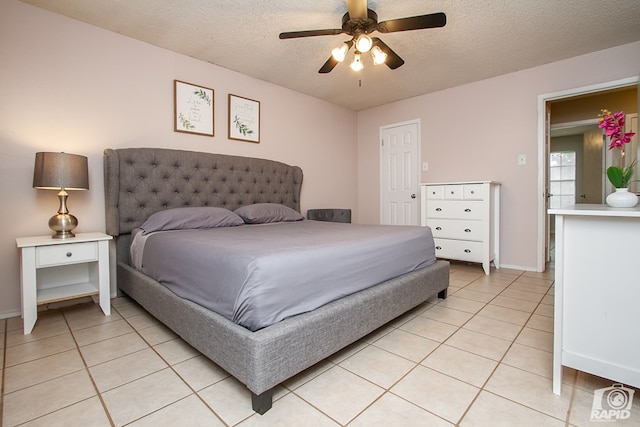 140 Van Zandt St, San Angelo, TX 76905 - bedroom featuring light tile patterned floors, a textured ceiling, baseboards, and a ceiling fan