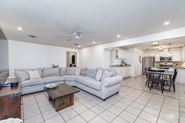 140 Van Zandt St, San Angelo, TX 76905 - living area with ceiling fan, light tile patterned floors, recessed lighting, and ornamental molding