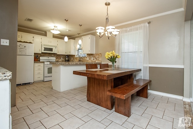 140 Van Zandt St, San Angelo, TX 76905 - kitchen with white appliances, crown molding, tasteful backsplash, a chandelier, and light tile patterned floors