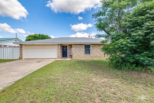 140 Van Zandt St, San Angelo, TX 76905 - view of front facade featuring a garage, driveway, and brick siding