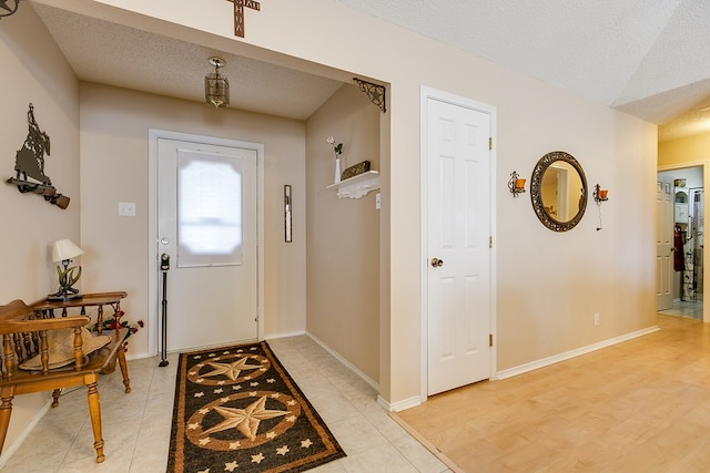 entryway featuring light hardwood / wood-style floors and a textured ceiling