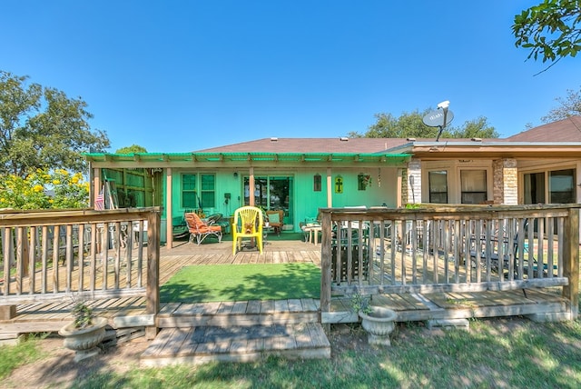 back of property with a wooden deck