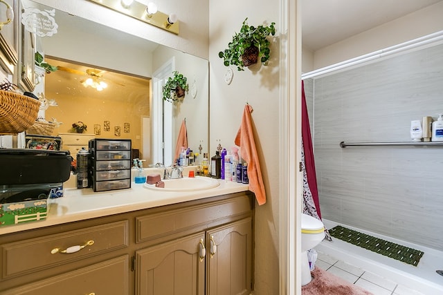 bathroom featuring vanity, toilet, tile patterned flooring, and a shower