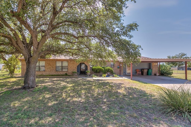 ranch-style house featuring a carport and a front yard