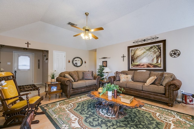 living room with lofted ceiling, wood-type flooring, and ceiling fan