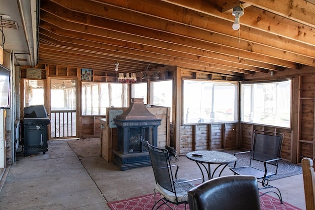 sunroom / solarium with a wood stove