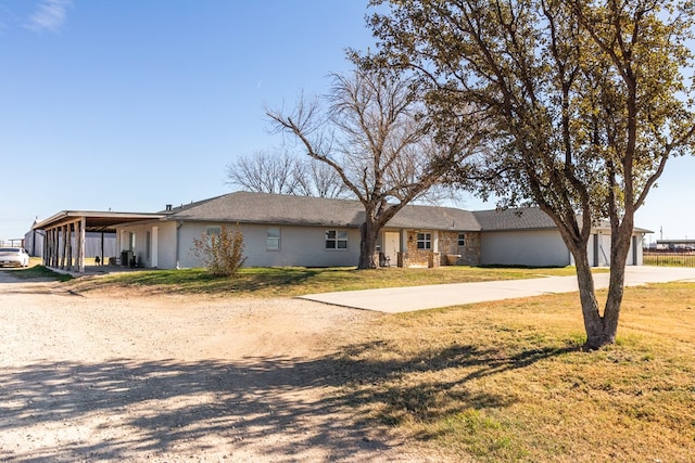 ranch-style house with a front lawn and a carport