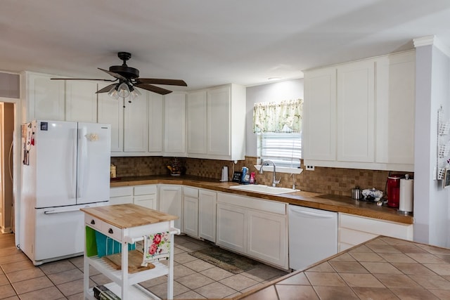 kitchen with white cabinetry, sink, decorative backsplash, light tile patterned floors, and white appliances