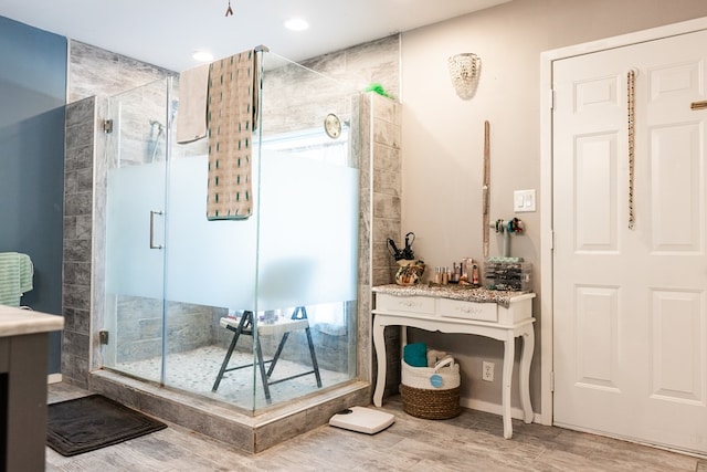 bathroom featuring a shower with door and wood-type flooring