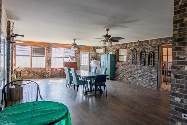 dining room featuring a wall mounted air conditioner, brick wall, hardwood / wood-style floors, and ceiling fan