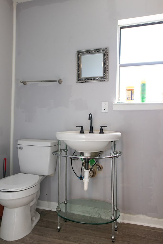 bathroom with hardwood / wood-style floors, sink, and toilet