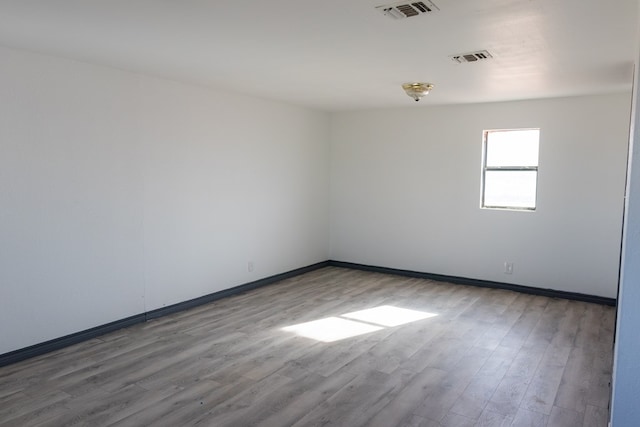 unfurnished room featuring hardwood / wood-style flooring