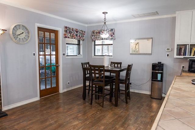 dining room featuring dark hardwood / wood-style flooring and ornamental molding