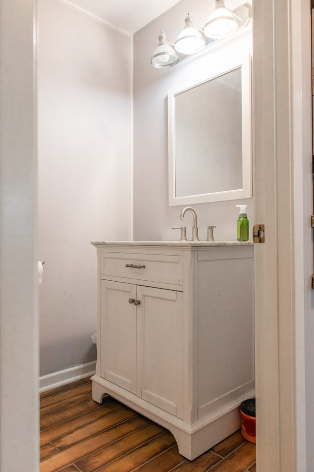 bathroom featuring hardwood / wood-style flooring and vanity