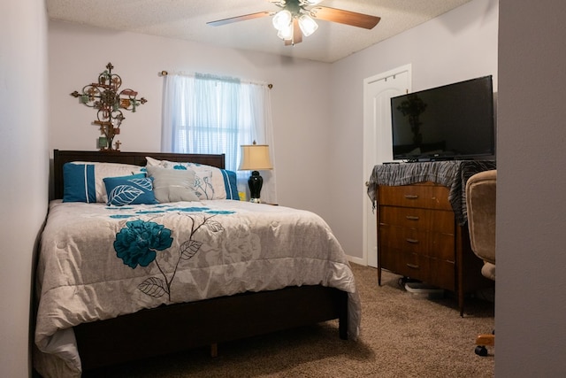 carpeted bedroom with a textured ceiling and ceiling fan