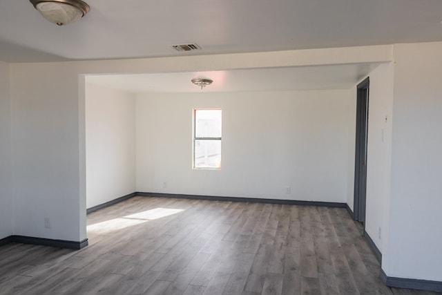 empty room with hardwood / wood-style flooring