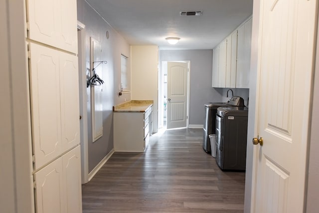 interior space with cabinets, dark wood-type flooring, independent washer and dryer, and a textured ceiling