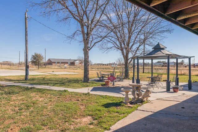 surrounding community featuring a gazebo, a patio, and a lawn