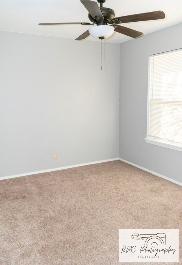 unfurnished room featuring ceiling fan and carpet