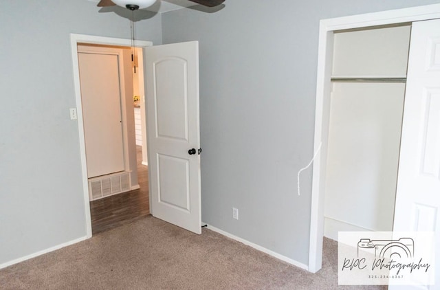 unfurnished bedroom featuring light colored carpet, ceiling fan, and a closet