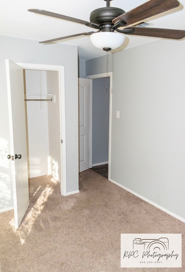 unfurnished bedroom with ceiling fan, carpet, and a closet