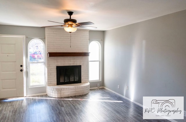 unfurnished living room featuring hardwood / wood-style floors, a wealth of natural light, and a fireplace