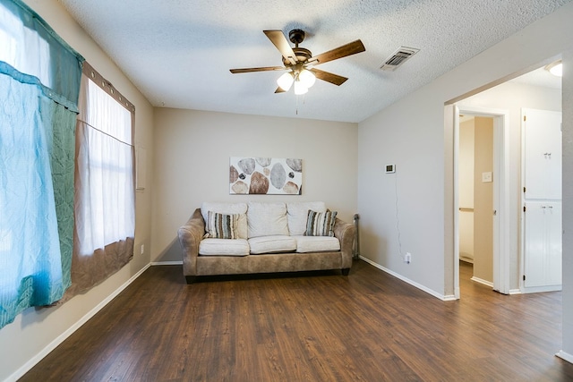 sitting room featuring a textured ceiling, wood finished floors, and visible vents