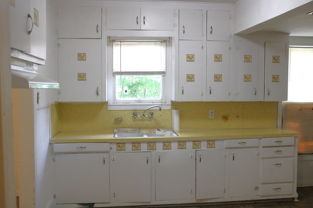 1008 10th St, Ballinger, TX 76821 - kitchen with light countertops, plenty of natural light, and white cabinetry