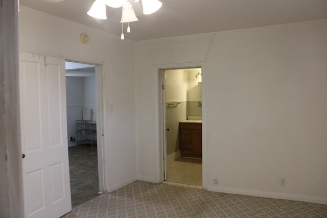 1008 10th St, Ballinger, TX 76821 - unfurnished bedroom with ensuite bath and baseboards