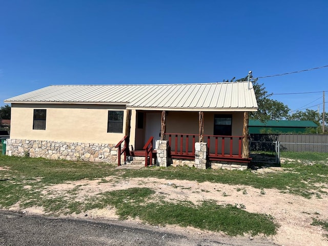415 Montague Ave, San Angelo, TX 76905 - view of front of house featuring a porch, stucco siding, and metal roof