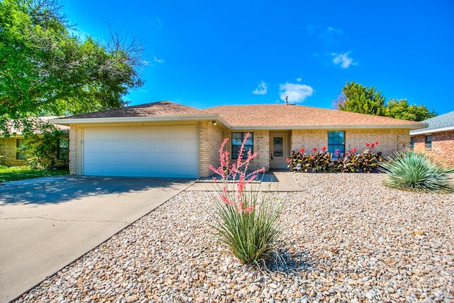 1617 Idaho Ave, San Angelo, TX 76904 - single story home featuring a garage, brick siding, and concrete driveway