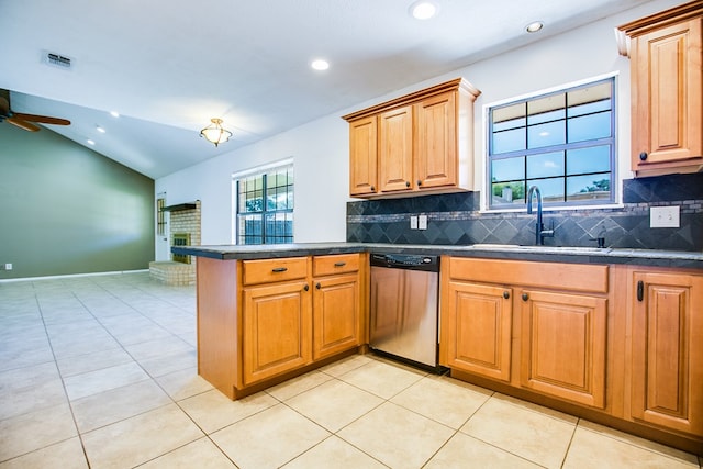 1617 Idaho Ave, San Angelo, TX 76904 - kitchen featuring stainless steel dishwasher, dark countertops, a peninsula, backsplash, and lofted ceiling