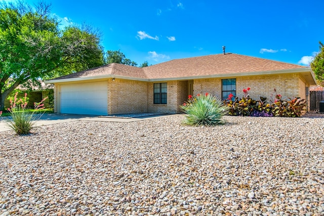 1617 Idaho Ave, San Angelo, TX 76904 - ranch-style home featuring brick siding, an attached garage, driveway, and roof with shingles