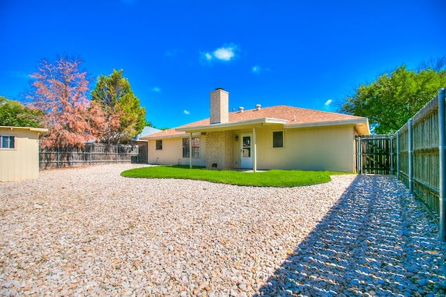 1617 Idaho Ave, San Angelo, TX 76904 - rear view of house featuring a chimney and a gate