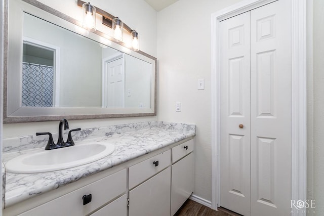 bathroom with vanity and wood-type flooring