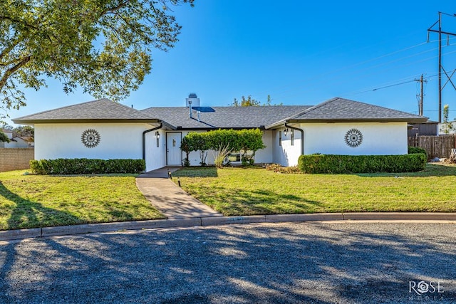 single story home featuring a front lawn