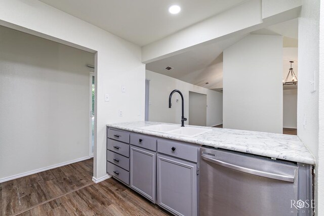 kitchen featuring gray cabinets, decorative light fixtures, dishwasher, sink, and dark wood-type flooring