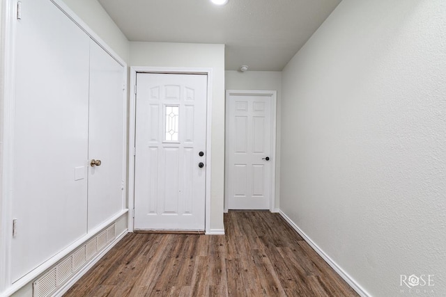 foyer entrance with dark wood-type flooring