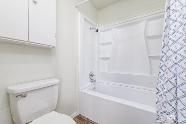 bathroom featuring toilet and shower / bath combo