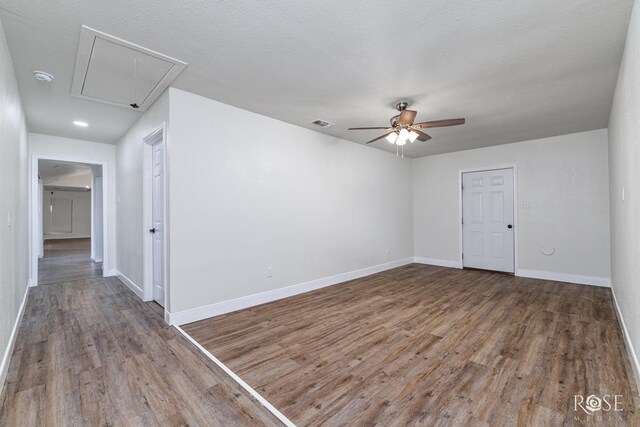 empty room with ceiling fan and hardwood / wood-style floors