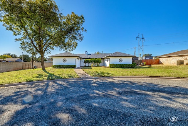 ranch-style house with a front lawn