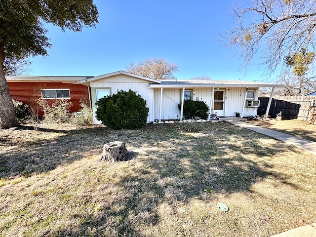 ranch-style house with cooling unit and a front yard