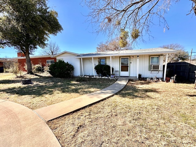 ranch-style house with cooling unit, a front yard, and fence