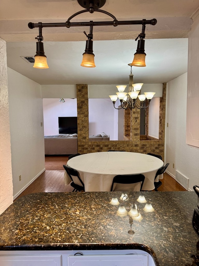 5214 Green Valley Trl, San Angelo, TX 76904 - dining space featuring dark wood-style flooring and a chandelier