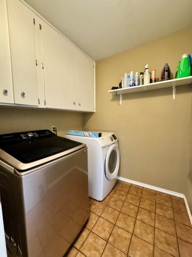 5214 Green Valley Trl, San Angelo, TX 76904 - washroom with independent washer and dryer, cabinet space, and light tile patterned flooring